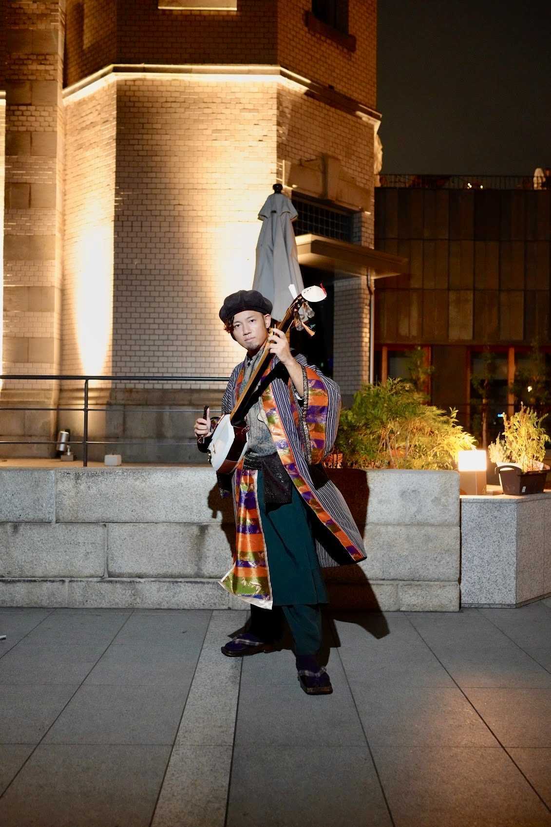 Masaki with shamisen at night